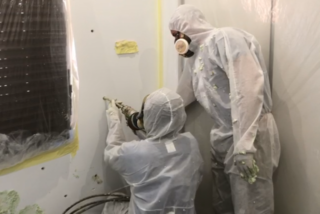 Pest control specialist applying fipronil termiticide to eliminate signs of termites in drywall